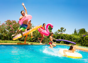 Friends Jumping into a Pool